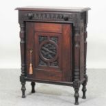 A 17th century style carved oak cabinet,