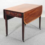 A Regecncy mahogany and crossbanded pembroke table,