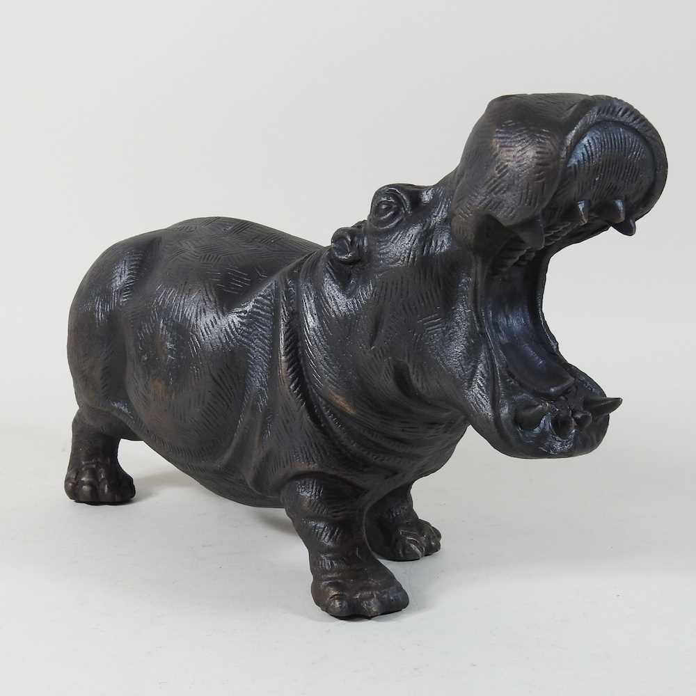 A bronzed metal model of a hippo