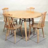 An Ercol light elm drop leaf dining table,