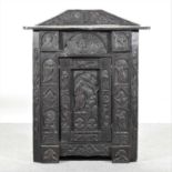 A 19th century heavily carved dark oak corner cabinet,