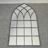 A tall arched garden mirror