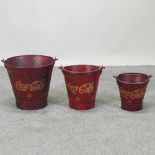 A set of three painted metal Coca Cola advertising buckets