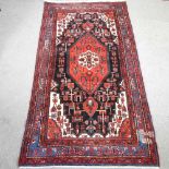 A Turkish woollen rug, with a central medallion,