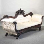 A 19th century style carved and cream uphoklstered sofa,