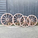 A pair of red painted wooden cartwheels,