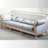 A large gilt framed and pale blue upholstered sofa,