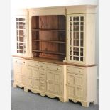 A large 20th century cream painted and pine breakfront dresser,