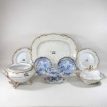 A 19th century extensive white glazed part dinner service, each piece bearing a family crest,
