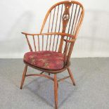 An Ercol elm armchair,