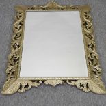 A large ornate gilt framed wall mirror, surmounted by a shell,