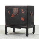 An oriental black lacquered box on stand,