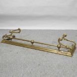 An Art Nouveau brass fender,