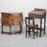 An early 20th century oak children's school desk and chair,