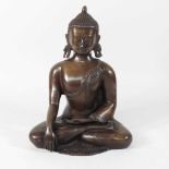 A reproduction bronze figure of a buddha
