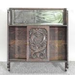 An early 20th century carved oak hanging cabinet,