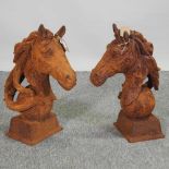 A pair of rusted horse head finials