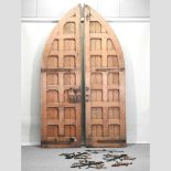 A pair of large antique pitch pine gothic style doors