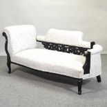 An Edwardian cream upholstered chaise longue,