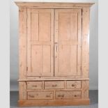 An antique pine wardrobe,