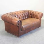 A modern brown leather upholstered button back chesterfield sofa,