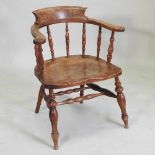 An early 20th century elm seated smokers bow chair,