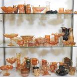 Three shelves of carnival and coloured glass,