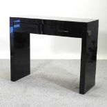 A Next black gloss chest of drawers,