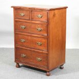 A late Victorian walnut chest of drawers,