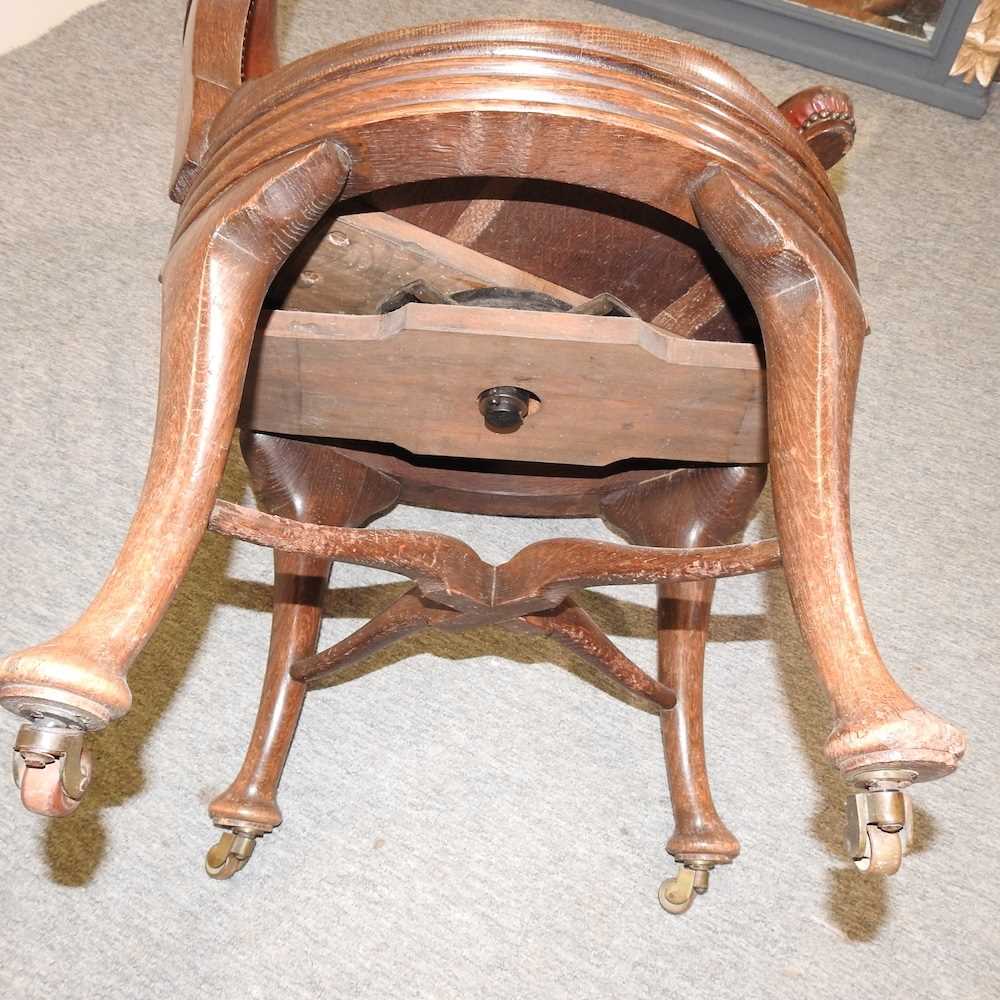 A late Victorian oak and leather upholstered swivel desk chair, - Image 2 of 6