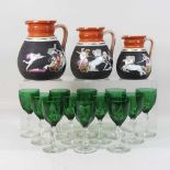 A set of early 20th century green and cut glass sherry glasses,
