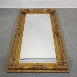 A large modern gilt framed wall mirror,