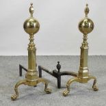 A pair of unusually large brass andirons,