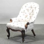 A Victorian button back armchair