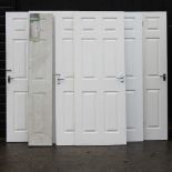 A collection of white painted interior doors