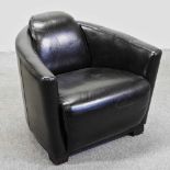 A contemporary black leather upholstered aviator style armchair