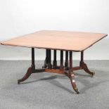 A Regency style rosewood crossbanded drop leaf dining table,