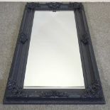 A large grey painted framed wall mirror,