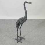 A bronzed garden model of a heron