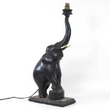 An early 20th century carved wooden table lamp,