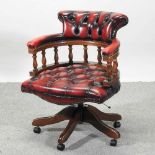 A modern red leather upholstered swivel desk chair