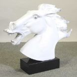 A painted plaster model of a horse head, on a marble base