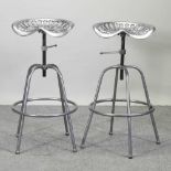 A pair of painted metal tractor seat stools