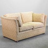 A yellow upholstered two seater sofa,