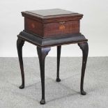 An early 20th century inlaid sewing table