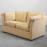 A yellow upholstered two seater sofa,