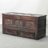 An 18th century carved oak mule chest,