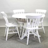 A modern white painted circular dining table,