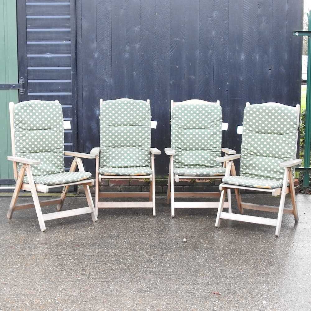 A set of four folding garden chairs,