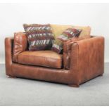 A brown leather upholstered armchair,
